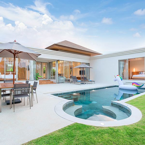 A modern vacation rental home featuring a pool and patio area, designed for a stylish accommodation website.