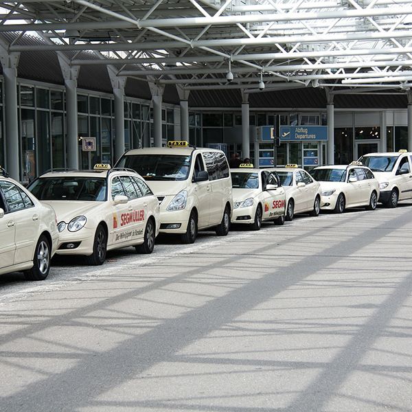 Parked cars in a airport parking bay, symbolizing website solutions for taxi and private hire businesses.