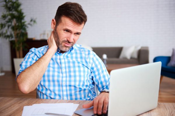 stressed man looking at his laptop